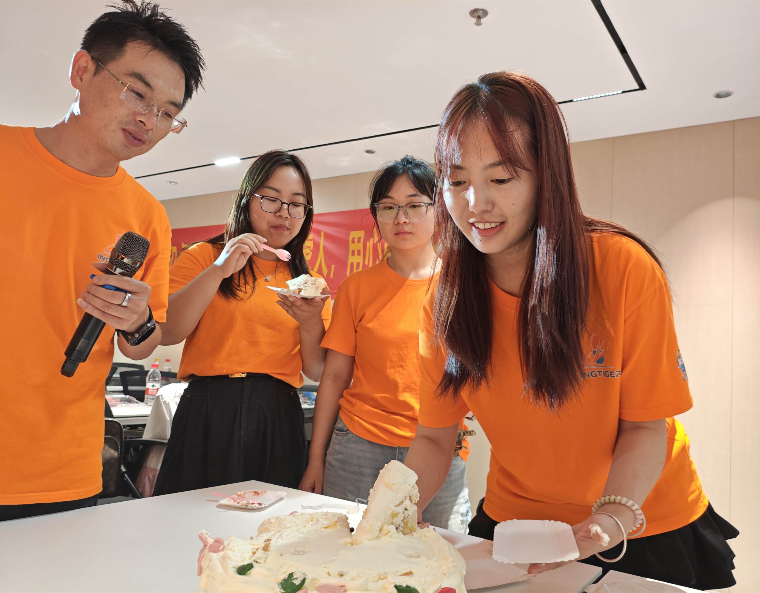 Ingtiger team sharing birthday cake during the 2026 semi-annual meeting